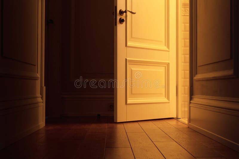 Light in the dark corridor from the open door royalty free stock photo